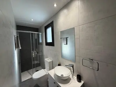 a bathroom with a sink and a toilet and a shower at Glabur Stays - Nicosia Elite 2BDR in Nicosia