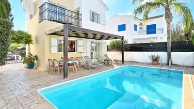 a swimming pool in front of a house at Villa Kos #7 in Paralimni