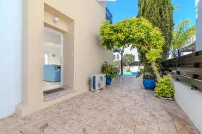 a courtyard in a house with potted plants at Villa Kos #7 in Paralimni