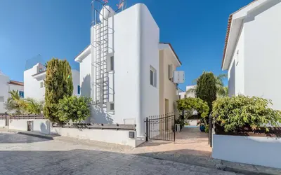 a white building with trees on the side of it at Villa Kos #7 in Paralimni