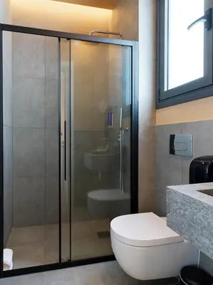 a bathroom with a glass shower with a toilet at Alinea Lano Old Town Center in Limassol