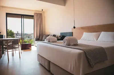 a bedroom with a large bed and a living room at Alinea Lano Old Town Center in Limassol