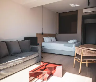 a living room with a bed and a couch and a table at Alinea Lano Old Town Center in Limassol