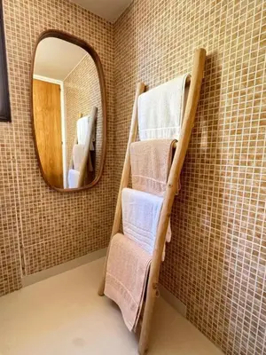 a bathroom with a towel rack and a mirror at Bohemian Oasis in Episkopi Lemesou