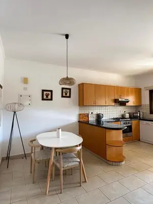 a kitchen with a table and a table and chairs at Bohemian Oasis in Episkopi Lemesou