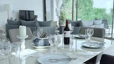 a white table with a bottle of wine and glasses at TooCoool Villa - Azure Seaview in Protaras