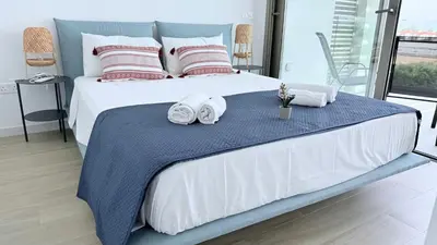 a bedroom with a large bed with towels on it at TooCoool Villa - Azure Seaview in Protaras