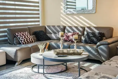 a living room with a couch and a table at Royal Nissi Mansion 3 bed lower part of villa in Ayia Napa
