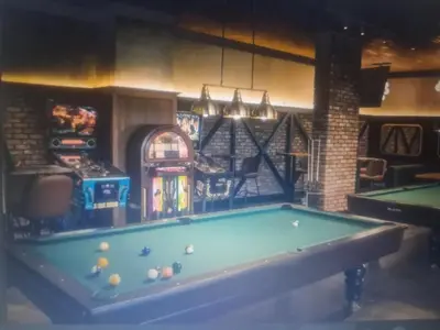 a billiard room with a pool table and a arcade at Courtyard Holiday Resort Studio in Iskele