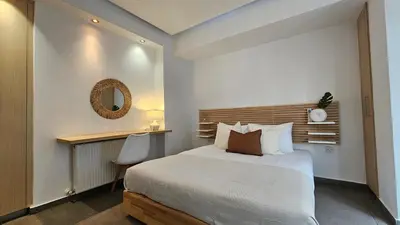 a bedroom with a bed and a desk and a mirror at Phaedrus Living Limassol Ocean Pearl Residence in Limassol