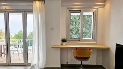 a room with a desk and two windows and a balcony at Phaedrus Living Limassol Ocean Pearl Residence in Limassol
