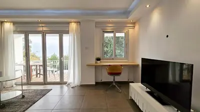 a living room with a large flat screen tv at Phaedrus Living Limassol Ocean Pearl Residence in Limassol