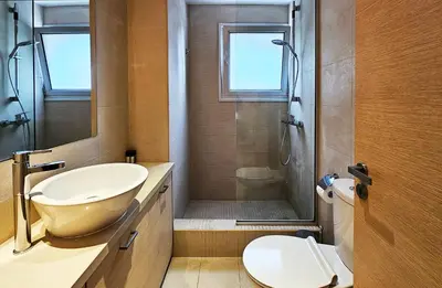 a bathroom with a sink and a shower and a toilet at Phaedrus Living Limassol Ocean Pearl Residence in Limassol