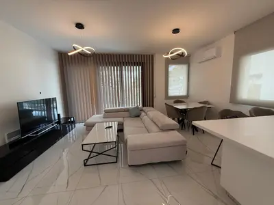 a large living room with a couch and a tv at Glabur Stays - Nicosia's Finest 2 Bedroom in Nicosia