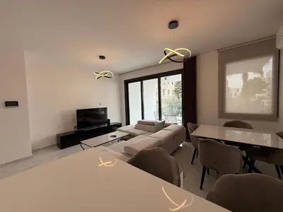 a living room with a couch and a tv at Glabur Stays - Nicosia's Finest 2 Bedroom in Nicosia