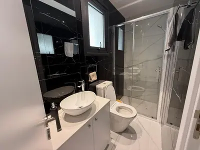 a bathroom with a toilet and a sink and a shower at Glabur Stays - Nicosia's Finest 2 Bedroom in Nicosia