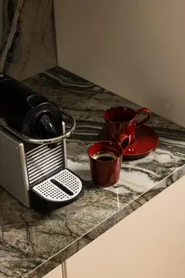 two cups of coffee sitting on a counter with two mugs at Interlace by Holistays in Engomi