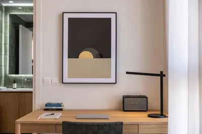 a desk with a picture on a wall with a laptop at Interlace by Holistays in Engomi
