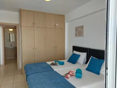 a bedroom with a bed with blue pillows at Tide Terrace 2 bdr apt in Kapparis, Protaras in Paralimni