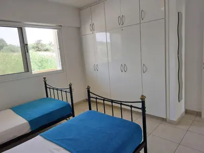 a bedroom with two bunk beds and a window at Nissi Retreat - Walk to Nissi beach! in Ayia Napa