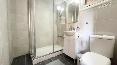 a bathroom with a shower and a toilet and a sink at Seaside Larnaca Makenzie- 50m to Beach in Larnaka
