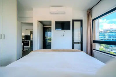 a bedroom with a white bed and a window at Element Stays City Suite in Nicosia