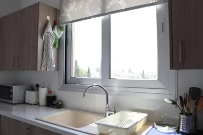 a kitchen with a sink and a window at Modern 2BR near UNIC & Engomi Mall in Lakatamia