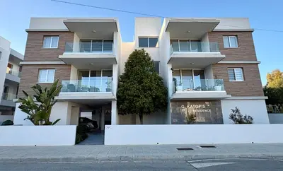 an apartment building with a sign in front of it at Modern 2BR near UNIC & Engomi Mall in Lakatamia