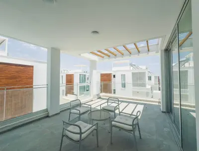 a room with chairs and a table on a balcony at Imperial Jade V4 - Villa Andriana in Protaras in Protaras