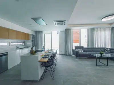a kitchen and living room with a couch and a table at Imperial Jade V4 - Villa Andriana in Protaras in Protaras