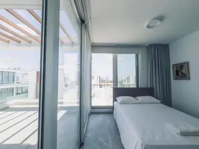 a bedroom with a bed and a large window at Imperial Jade V4 - Villa Andriana in Protaras in Protaras