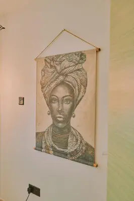 a painting of a woman on a wall at Rosam Seaview Holiday apartment in Ayia Napa