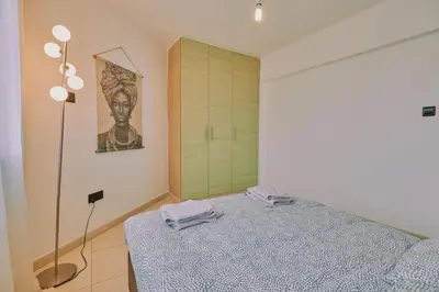 a bedroom with a bed with two towels on it at Rosam Seaview Holiday apartment in Ayia Napa
