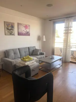 a living room with a couch and a table at Ithaki Phinikoudes Apartment No. 205 in Larnaka