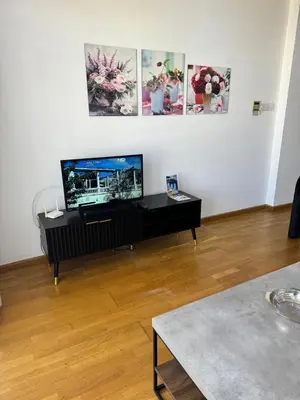 a living room with a flat screen tv on a table at Ithaki Phinikoudes Apartment No. 205 in Larnaka