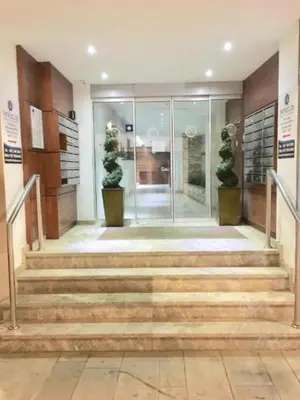 a lobby with stairs and potted plants at Ithaki Phinikoudes Apartment No. 107 in Larnaka
