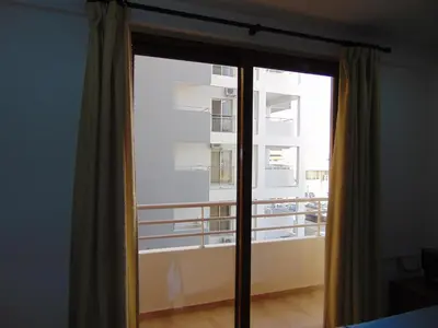 a sliding glass door with a view of a balcony at Ithaki Phinikoudes Apartment No. 107 in Larnaka