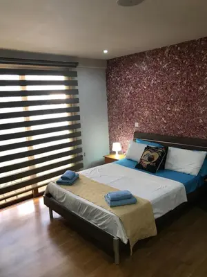 a bedroom with a bed with two towels on it at Ithaki Phinikoudes Apartment No. 207 in Larnaka