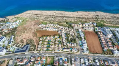 an aerial view of a city with houses and the ocean at Anthorina Greco Villa #18 in Protaras