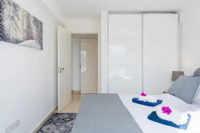 a living room with a white bed and a couch at Pervolia Seaview Escape in Pervolia