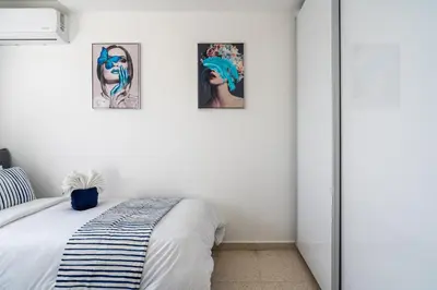 a bedroom with three pictures on the wall at Pervolia Seaview Escape in Pervolia