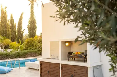 a kitchen with a sink and a pool at villa Ionion H32 in Ayia Napa