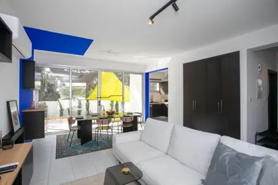 a living room with a white couch and a dining room at Palmove Renovated Meneou House in Larnaka
