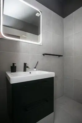 a bathroom with a white sink and a mirror at Palmove Renovated Meneou House in Larnaka
