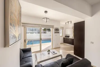 a living room with a couch and a table at villa Palms 31 in Protaras