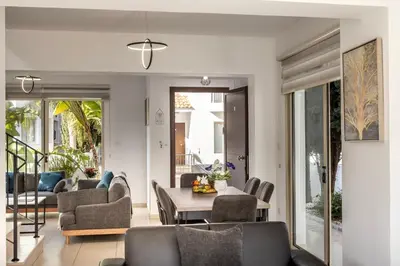 a living room with a table and chairs at villa Palms 31 in Protaras