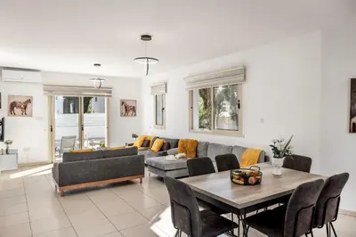 a living room with a couch and a table at Villa Palms 32 in Protaras