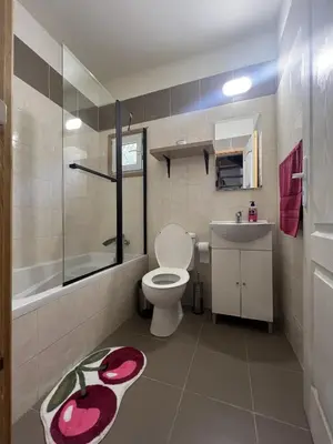 a bathroom with a toilet and a sink and a shower at Cherry Holiday House in Khandria
