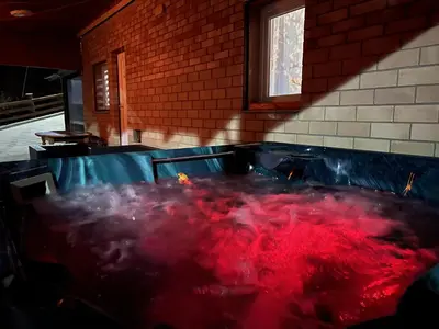 a hot tub in a room with red smoke at Cherry Holiday House in Khandria
