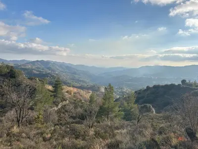 a view of a valley with mountains and trees at Cherry Holiday House in Khandria